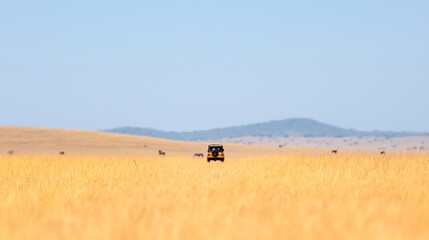 Obraz premium Safari jeep in african savannah with distant wildlife and mountains