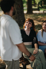 A group of adults seated on a bench enjoying a friendly conversation in a park. The setting portrays warmth, relaxation, and relationships in a natural outdoor environment.