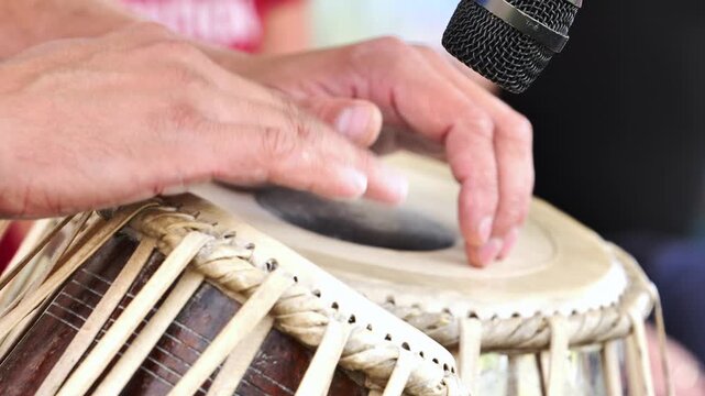 Musician playing tabla with microphone in India
