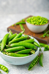 Fresh green pea pods with green peas on a wooden background. Sweet green peas. Green pea beans vegetables. Vegan. healthy vegetable. Copy space