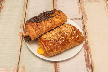 Classic butter Neapolitan pastries with a perfect swirl, topped with smooth pastry cream and powdered sugar