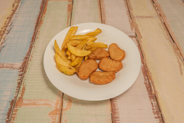 Chicken nuggets coated with crushed corn, giving them a bright yellow color and extra crunchy texture