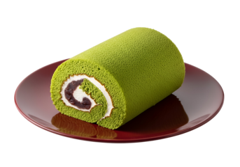A vibrant green matcha roll cake, adorned with a creamy white filling and red bean paste, rests elegantly on a rich maroon plate against a stark black backdrop.