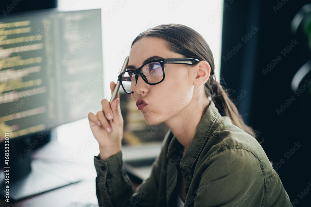 Aufkleber charming woman deep in thought while analyzing code on a computer monitor in a casual office environ