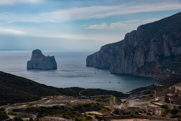 A body of deep blue-gray water stretches across the mid-ground, interspersed with small,...