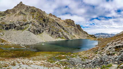 Panorama of Lunghin Lake and the surrounding mountains in Engadine, Switzerland.