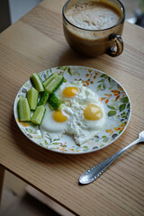 Breakfast. Fried eggs and cucumbers