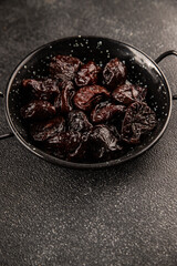 Prunes smoked plum portion size natural product tasty snack fresh delicious gourmet food background on the table rustic top view copy space keto and paleo diet vegetarian and vegan food