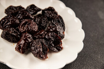 Prunes smoked plum portion size natural product tasty snack fresh delicious gourmet food background on the table rustic top view copy space keto and paleo diet vegetarian and vegan food