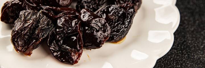 Prunes smoked plum portion size natural product tasty snack fresh delicious gourmet food background on the table rustic top view copy space keto and paleo diet vegetarian and vegan food