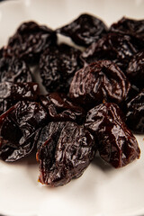 Prunes smoked plum portion size natural product tasty snack fresh delicious gourmet food background on the table rustic top view copy space keto and paleo diet vegetarian and vegan food