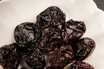 Prunes smoked plum portion size natural product tasty snack fresh delicious gourmet food background...