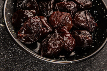 Prunes smoked plum portion size natural product tasty snack fresh delicious gourmet food background on the table rustic top view copy space keto and paleo diet vegetarian and vegan food