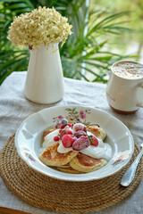 Pancakes with cream and berries.
