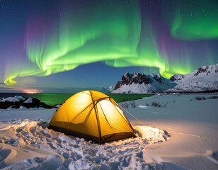 Yellow camping tent glowing in snowy landscape under vibrant green northern lights with mountain and water background at night