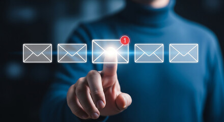 A person taps a glowing digital envelope symbolizing the anticipation of receiving an important email highlighted