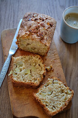Cinnamon apple cake (bread) on a wooden table. A piece of cake.