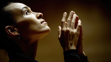Female Profile with Raised Hands in Prayer, Contemplation and Reflection in Soft Lighting