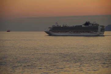 Scenic panoramic seascape view of Ocean and clouds and blue hour twilight sky with cruiseship...