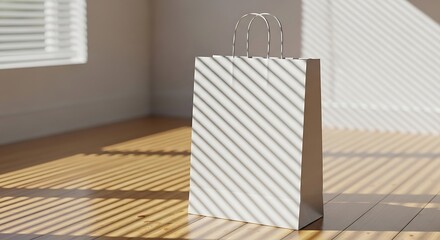 Paper shopping bag stands on wooden floor in sunlit room, casting striped shadows from window blinds, creating minimalist and serene atmosphere.