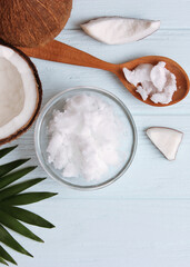 coconut oil and coconuts, palm branches close up. Vertical photo format