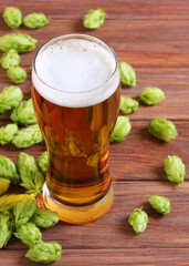 Beer, wheat and hops on the table.. Vertical photo format