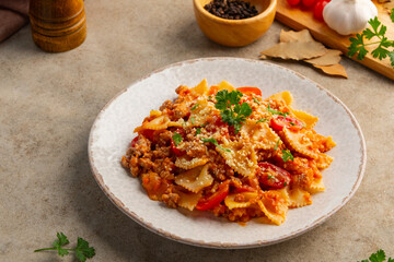bowties pasta with Meat Sauce,Easy Farfalle with a simple tomato sauce with ground pork and beef in white plate.bolognese pasta.
