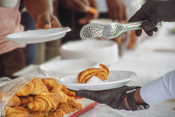 Pastry service at a buffet – Pain au chocolat served with tongs
