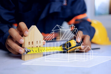 construction evaluation concept house design engineer using a tape to measure the length of wooden...