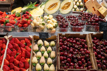 Cherries and red and white strawberries for sale at a market