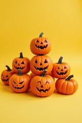 Pile of carved orange pumpkins with smiling faces lit by an unseen source set against a bright yellow backdrop