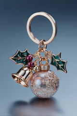 studio shot of a luxury 3d keychain with Christmas-themed charms (holly leaves, bell, snow globe), sharp details, high-end product photography lighting, clean gradient background