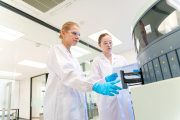 Scientists operate advanced laboratory equipment in a modern research facility