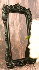 Ornate black framed rectangular mirror