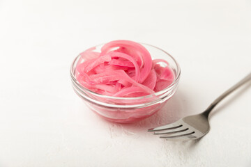Pickled onions in a glass jar on the table. pickled red onion. Vegetarian spicy dish. Delicious homemade marinated pickled purple onions . Space for text. Copy space.