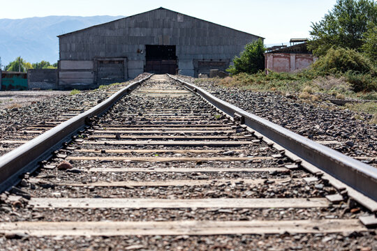 The old abandoned industrial building, to which the railway tracks lead, is a warehouse hangar for storing, loading and unloading goods, as well as industrial activities.
