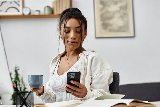 Young woman enjoying a relaxing moment at home while sipping coffee and using her phone - Powered by Adobe