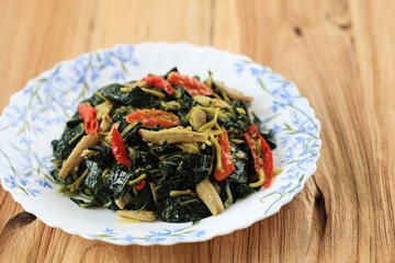 Stir Fry Papaya Leaves or Tumis Daun Pepaya Made from Boiled Papaya Leaves with Spice and Chilli