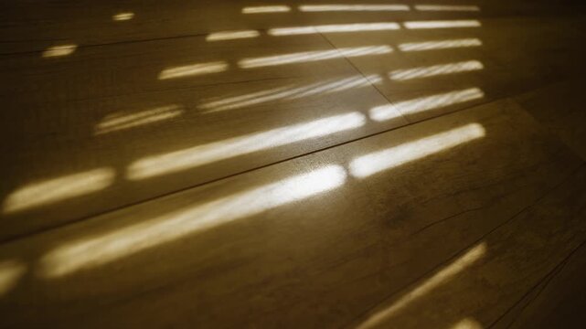Abstact shadows and light on wooden parquet floor in home in morning light. Early sunlight or afternoon strong warm light shining through cracks in window shutters or blinds. Fresh air and energy