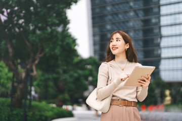 Happy smiling confidence business asian entrepreneur woman holding digital tablet and coffee cup