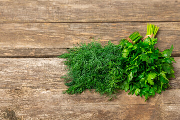 Dill and parsley on the texture table. Mixed bunch of fresh parsley and dill. Fresh aromatic spicy greens. Spices and herbs. Space for text. Copy space