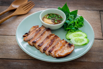 Grilled pork neck and thai spicy dipping sauce on plate