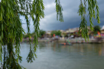 Happy european family, visting Hoi An city in Vietnam for a summer vacation, trying traditional food na watching the show in Memories Land