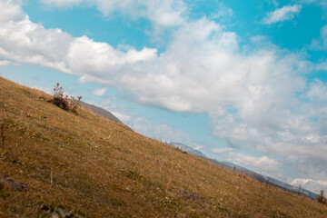 View from an angled mountain towards the clouds