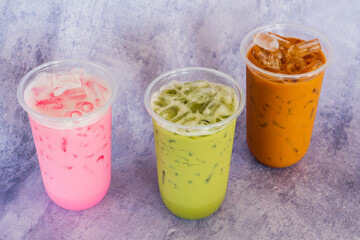 Various cold drinks  on grey table in cafe.