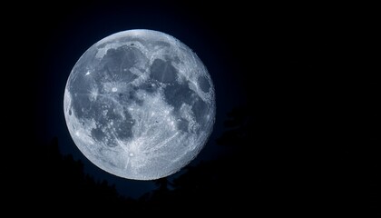 the full moon illuminates the night sky with its intense silvery glow creating a magical atmosphere