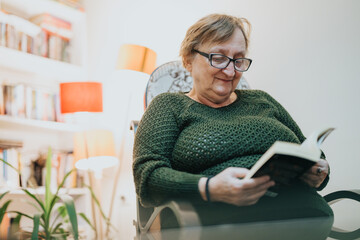 A senior woman reads contentedly in her living room, surrounded by books and warm lighting,...
