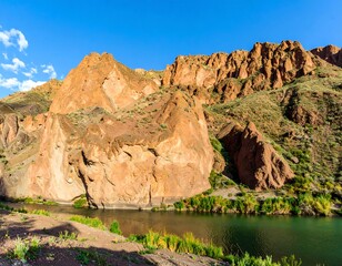 Rocky landscape by a river under a blue sky