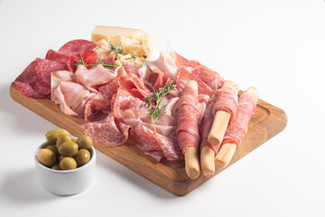 Charcuterie board. Antipasti appetizers of meat platter with salami, prosciutto crudo or jamon and olives.
