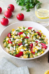 Pasta salad with tomatoes, zucchini, corn and feta cheese. Healthy eating. Vegetarian food.